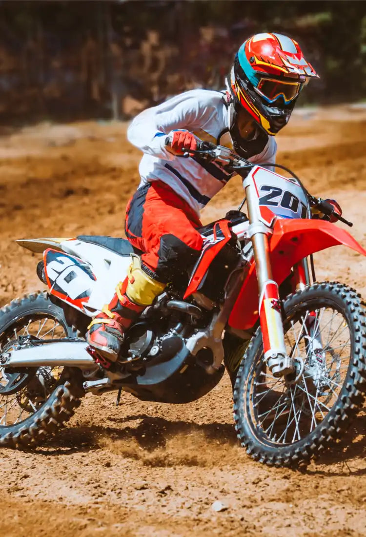 A motocross dirt bike with a rider in full gear.